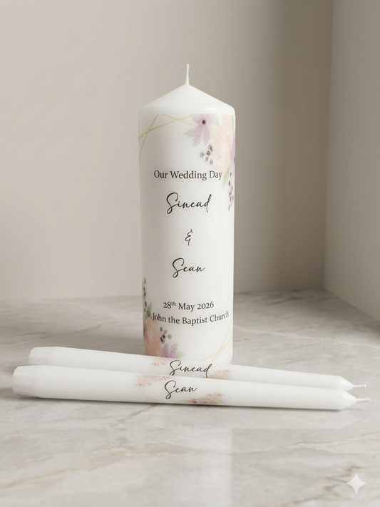 Personalized wedding candle with floral design and text on a marble surface.